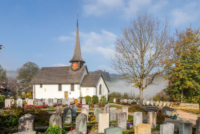 View of cemetery against church in switzerland