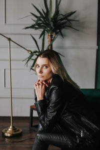 Portrait of young woman sitting outdoors