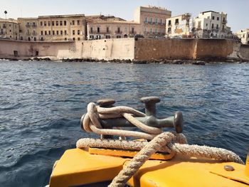 Ropes tied on bollard by sea