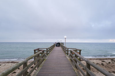 Pier over sea against sky