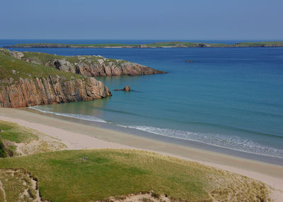 Scenic view of sea against clear blue sky