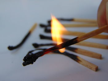 Close-up of burning candles on wood