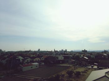 Houses in town against sky