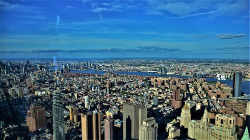 High angle view of buildings against blue sky