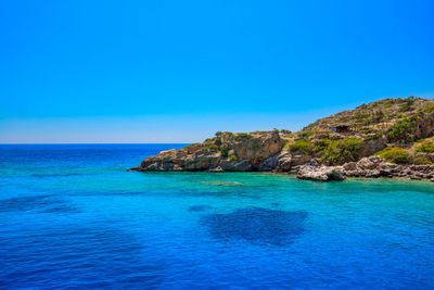 Scenic view of sea against clear blue sky