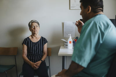 Senior woman discussing with male doctor in hospital