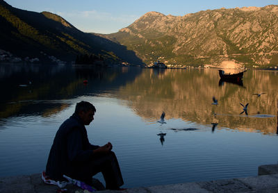 Man sitting by lake