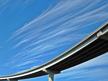 Low angle view of elevated road against blue sky