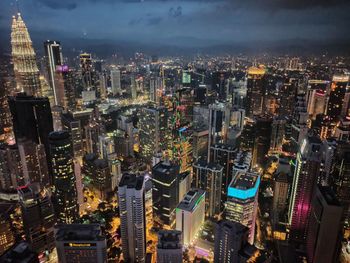 High angle view of city lit up at night