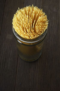 Close-up of spaghetti in jar on table