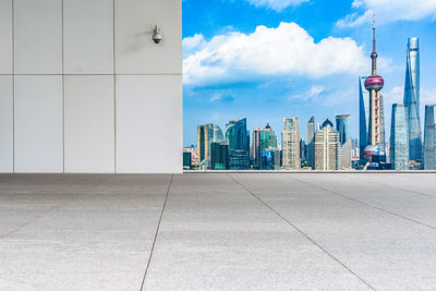 View of modern buildings against cloudy sky