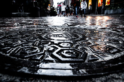 Close-up of wet manhole on street