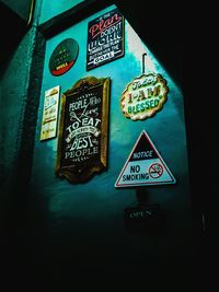 Low angle view of information sign on wall