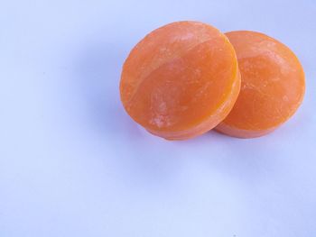 High angle view of orange fruit on white background