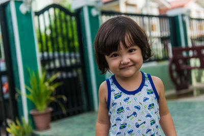 Portrait of smiling boy standing outdoors