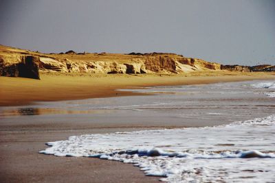 Scenic view of beach against clear sky