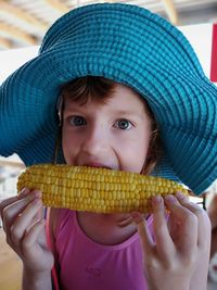 Close-up portrait of girl eating corn