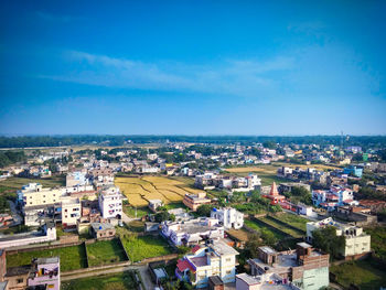 High angle view of townscape against blue sky