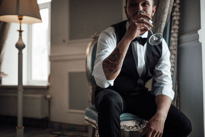 Young man sitting on seat at home