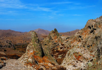 Rock formations on landscape against sky