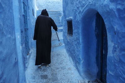 Rear view of men standing against wall