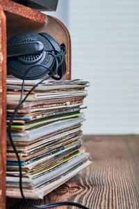 Close-up of records and headphones in box against gray background