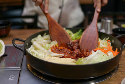 Close-up of person preparing food in restaurant