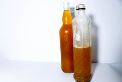 Close-up of drink served on table against white background