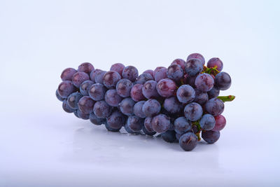 Close-up of grapes against white background