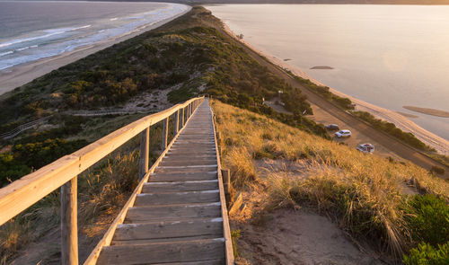 Wooden footbridge leading towards sea