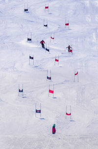 High angle view of people skiing on snow covered field