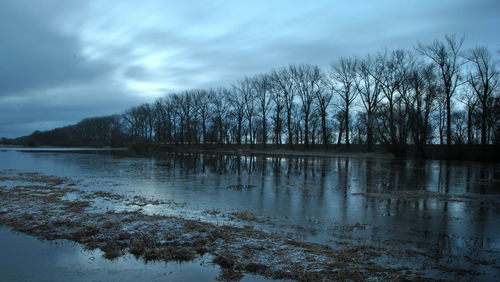 Scenic view of lake against sky during winter