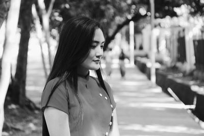 Thoughtful young woman standing outdoors