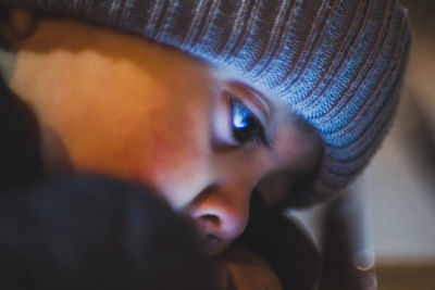 Close-up of cute boy looking down in darkroom