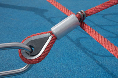 Close-up of playground equipment tied on metal