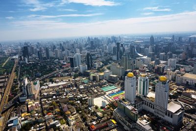 High angle view of modern buildings in city against sky