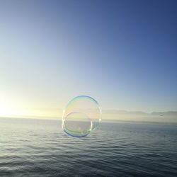 Bubbles over sea against clear sky
