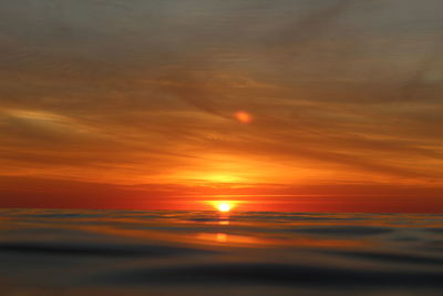 Scenic view of sea against romantic sky at sunset