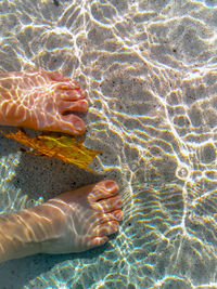 Soaking my feet in the cool pool water.