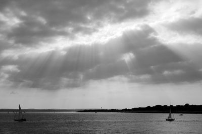 Sailboat sailing on sea against sky