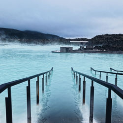 Scenic view of swimming pool by sea against sky
