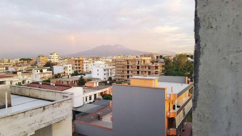 High angle view of buildings in town against sky