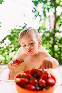 Cute boy eating fruit