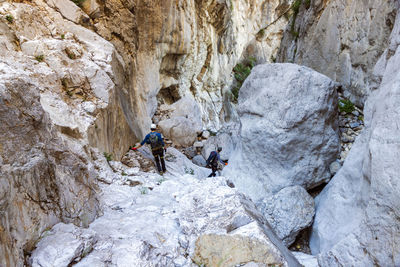 Rear view of man skiing on rock