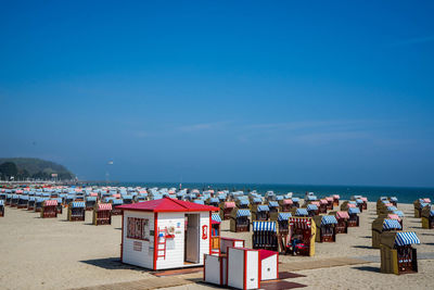 Group of people on beach against clear sky