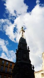 Low angle view of building against cloudy sky