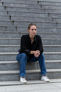 Beautiful woman sitting on steps