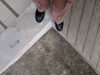 Low section of woman standing on staircase