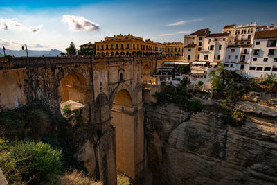 Arch bridge over buildings in city