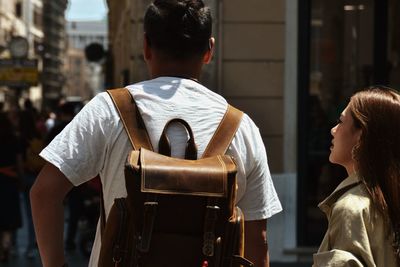 Rear view of people sitting in city